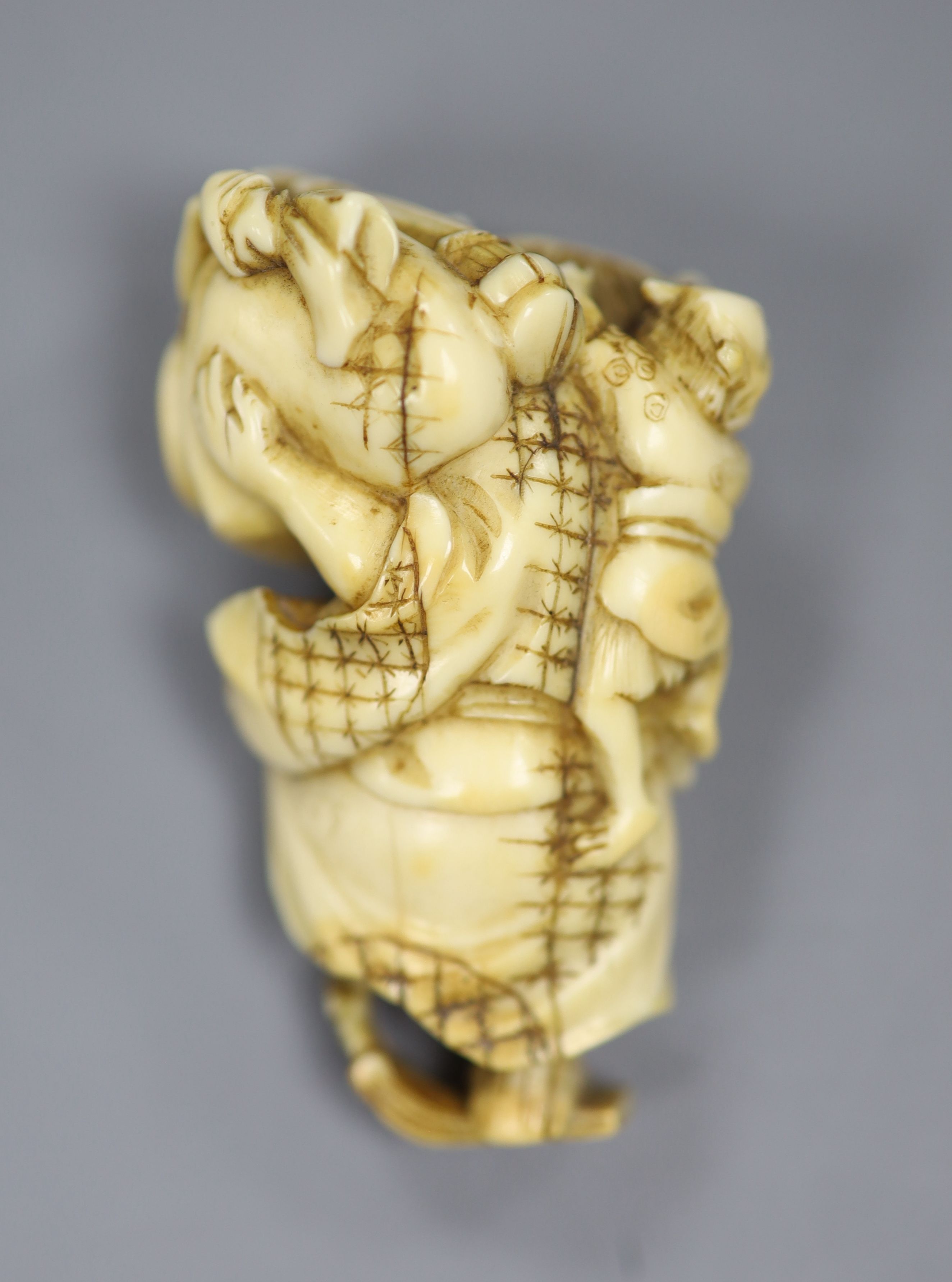 A 19th century Japanese carved ivory okimono of two oni, height 5cm